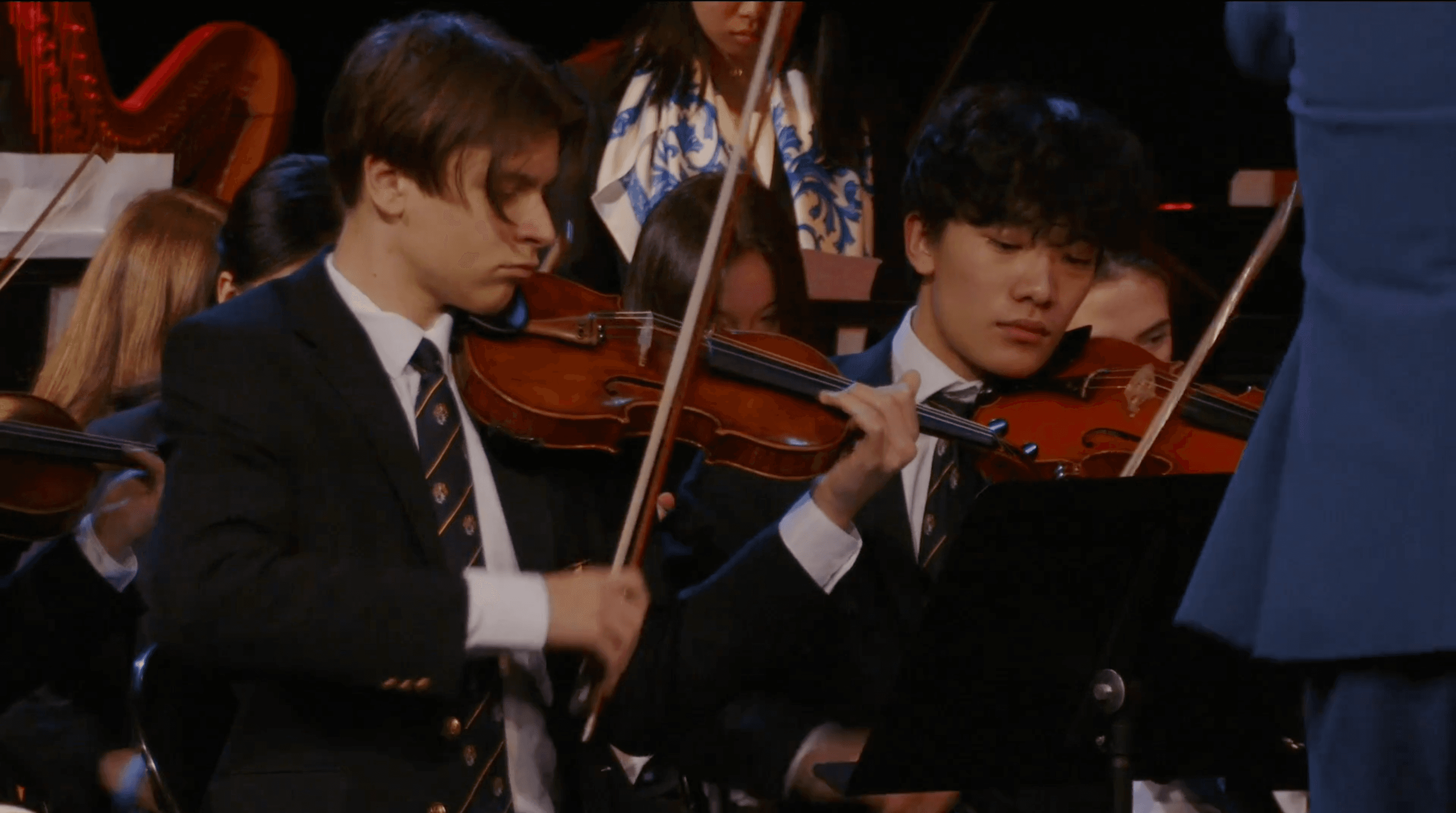 Alan playing in an orchestra violin section