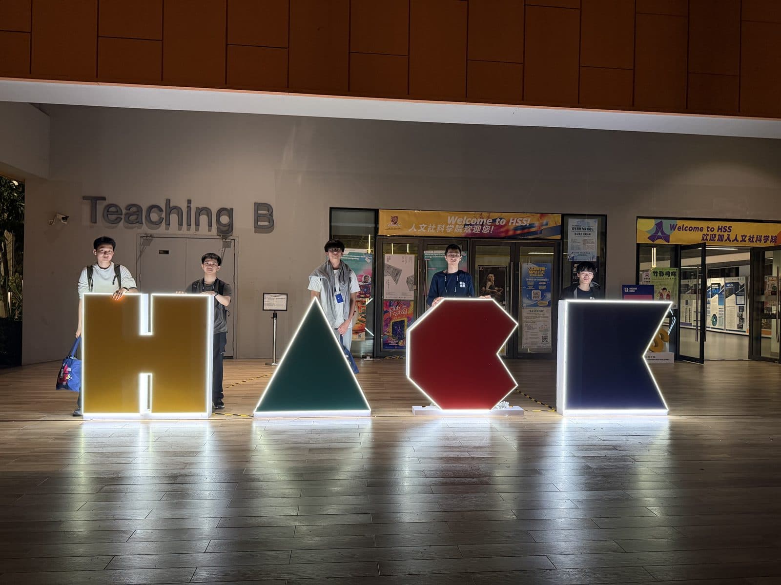 Large lit-up letters spelling HACK in a lobby