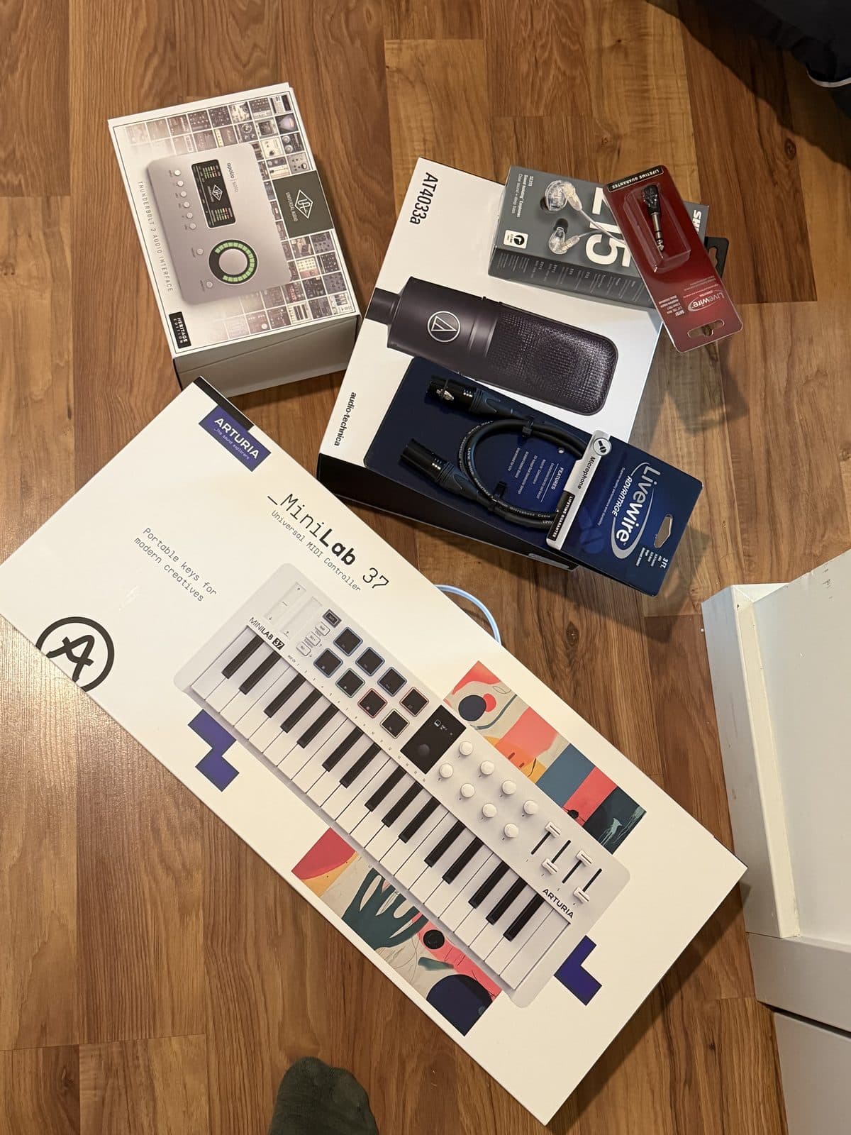 A MIDI keyboard and boxed hardware on a desk