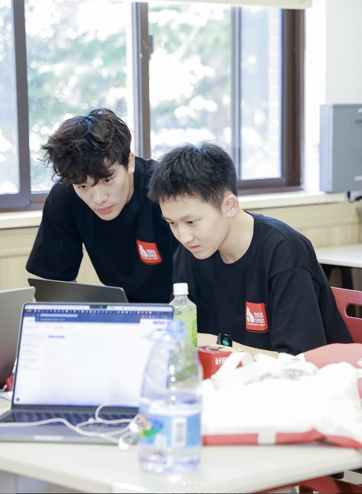 Two students working together at a laptop